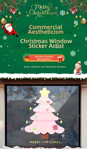 Close-up of pink Christmas tree window sticker with festive ornaments and star