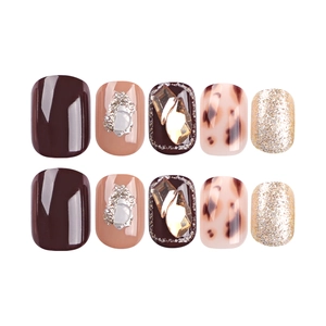 Press-on nail set featuring dark brown amber patterns and 3D gemstones with glitter