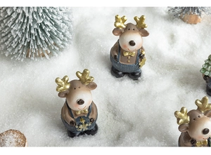 Detail of hand-painted resin reindeer figurines in snow setting for Christmas decor