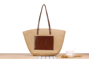 Close-up of a woven straw tote bag on a wooden table with elegant minimalist decor