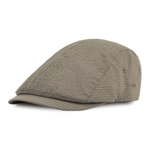 Detail shot of breathable textured fabric and metal logo plaque on the summer beret cap