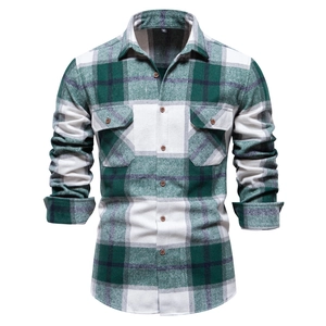 Detail view of green and white plaid long sleeve shirt with double pockets and flannel texture