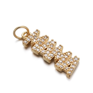 Detail shot of the gold-plated MAMA pendant featuring sparkling cubic zirconia crystals