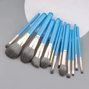 Thirteen piece blue makeup brush set with soft grey synthetic bristles and gold ferrules