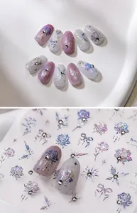 Detailed macro view of iridescent rose and butterfly nail stickers with crystal accents