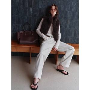 Chic dark brown faux fox fur cashmere vest paired with beige casual wear and leather tote