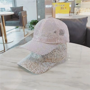 Close-up of sparkling sequin details on light pink and silver baseball caps