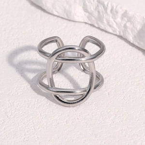 Detailed view of silver multi-layer intertwined geometric stainless steel open ring