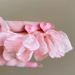 Detail of pink fabric flower earrings with heart shape connector for summer beach style