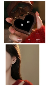 Macro detail of S925 sterling silver snowflake stud earrings in a heart wood gift box