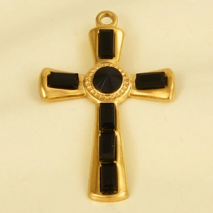 Macro detail of a 304 stainless steel gold cross pendant featuring a black crystal inlay