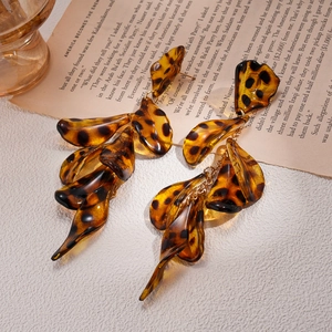 Chic leopard print acrylic petal earrings with golden hardware on a vintage background
