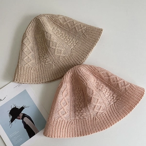 Detail of cable knit pattern on summer cotton linen bucket hats in beige and pink colors