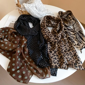 Close-up of lightweight chiffon scarves with leopard, polka dot and zebra patterns