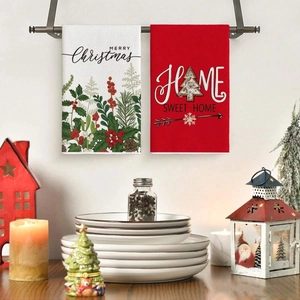 Close-up of festive Christmas kitchen towels with Merry Christmas and Home Sweet Home text