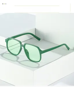 Detail shot of vintage green square sunglasses on a white minimalist geometric background