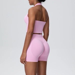 Close-up of pink seamless yoga set showing racerback sports bra and high waist lifting shorts