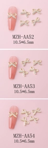Detailed view of alloy bow nail charms with rhinestones and pearls in 10.5x6.5mm size