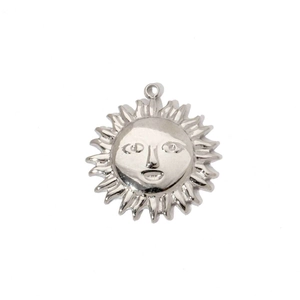 Detailed macro view of a silver sun face pendant with radial sunburst rays in titanium steel