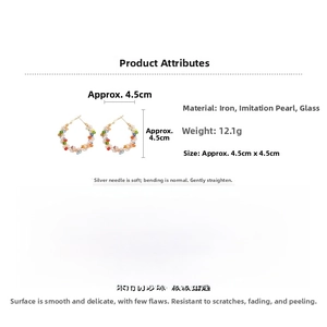 Detail view of 4.5cm colorful beaded hoop earrings with gold wire and pearl accents