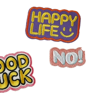 Embroidered patches set with Happy Life and Good Luck slogans on white background