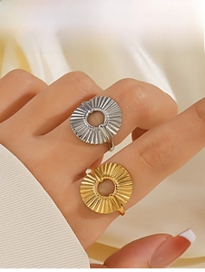 Detail of 18K gold and silver plated hollow circular rings with pleated metal texture