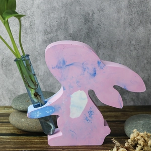 Macro detail of Easter bunny vase with marble texture holding a glass hydroponic tube