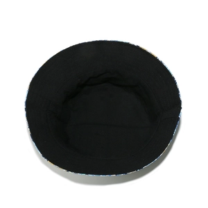 Detail view of sunflower pattern print on the brim of a reversible cotton bucket hat