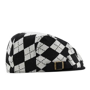 Detail of vintage black and white argyle pattern with bronze metal buckle on side