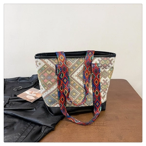 Close-up of ethnic woven tote bag with geometric patterns and reinforced black handles