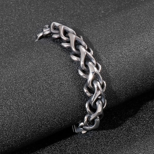 Close-up of thick gunmetal stainless steel chain link bracelet with polished finish