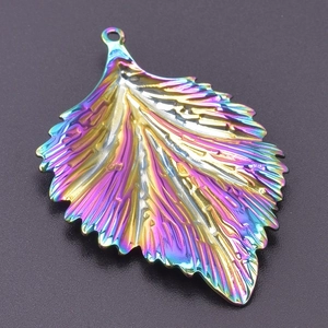 Detail view of the rainbow plated leaf pendant with intricate leaf vein texture and hanging loop