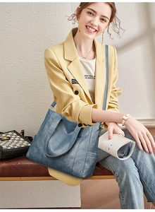 Chic blue tote bag shown in professional daily wear scenario with a yellow blazer