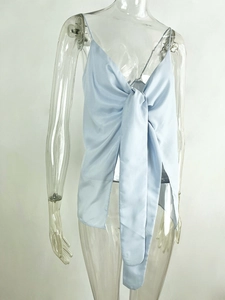 Detail of light blue satin top featuring a large front knot and elegant draped v-neckline