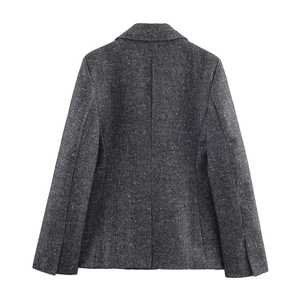 Back view of a charcoal grey herringbone tweed blazer jacket with a pleated skirt-style hem