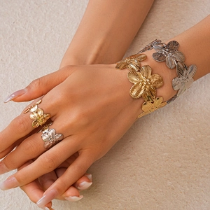 Close-up of metallic flower petal texture on gold and silver statement jewelry set