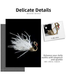 Detail showing vintage swan brooches with black and white feathers and pearls