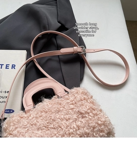 Detail view of pink faux wool box bag showing curly texture and adjustable shoulder strap