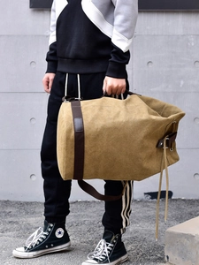 Vintage khaki canvas duffel bag with durable shoulder straps for travel and sports