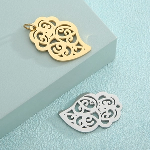 Hollow leaf-shaped stainless steel pendants in gold and silver finishes on blue stands