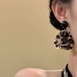 Vintage leopard resin camellia petal earrings with black rose detail shown on model