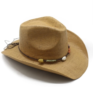 Detailed close-up of woven straw fedora featuring bohemian bead and cord hatband
