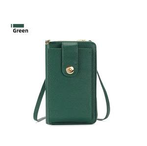 Detail of green litchi grain leather crossbody phone bag with gold metal buckle