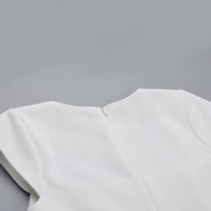 Close-up of a white mini dress featuring a concealed back zipper and a square neckline