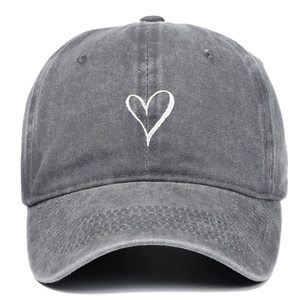 Faded grey washed cotton baseball cap with minimalist white heart embroidery on the front