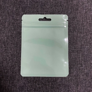 Close-up of light green transparent resealable storage bag with hang hole and zip lock