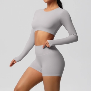 Detail of light gray yoga set featuring thumb holes and high waist compressive shorts