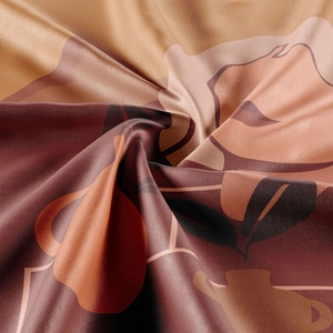 Detail showing the silky satin texture and abstract botanical pattern of the wall tapestry