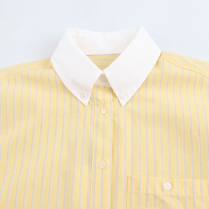Detail of yellow and white striped shirt featuring white collar and buttoned chest pocket