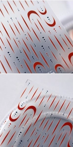 Macro shot of 5D geometric nail art stickers with red and blue lines on transparent film